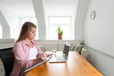 pregnant woman looking for answers on her laptop